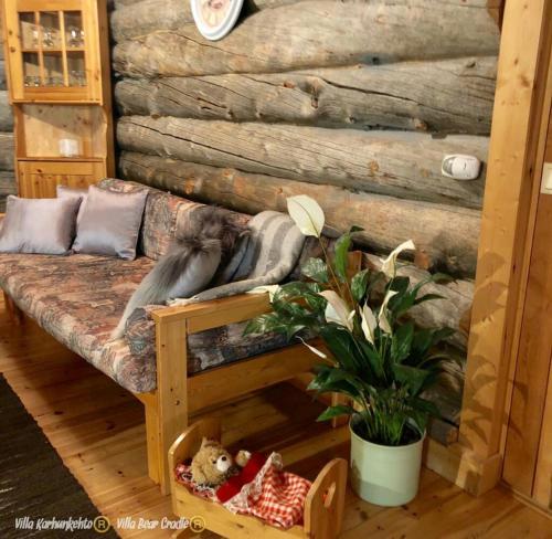 a dog laying on a couch in a room at Villa Karhunkehto in Luosto