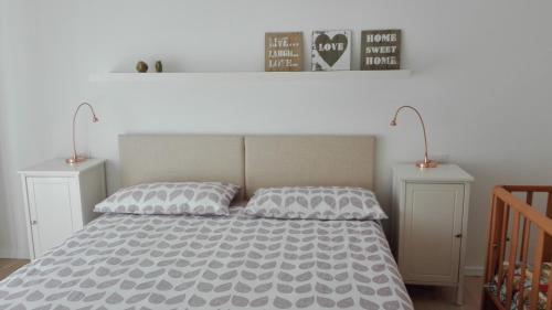 a bedroom with a large bed with two night stands at Appartamento caneve in Arco