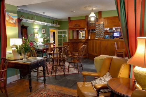 a living room with a table and chairs at The Wynnstay in Machynlleth