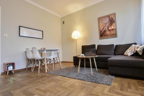 a living room with a couch and a table at Smulikowskiego 9 in Warsaw