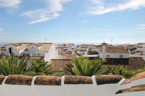 a view of a city from a white fence at Boutique Hotel Pueblo in Benalmádena