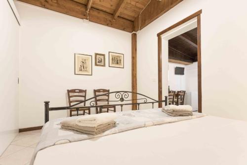 a bedroom with a bed and some chairs at Eloka in Torre Squillace