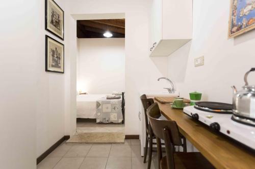 a kitchen with a counter and a room with a bed at Eloka in Torre Squillace