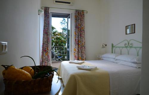 a room with a bed, table and window at Hotel Europa in Ischia
