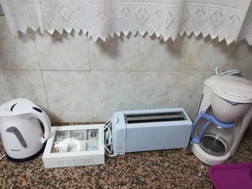a toaster sitting on the floor next to a toilet at Cueva Tradicional El capricho in Guadix