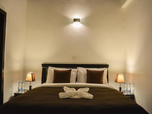 1 dormitorio con 1 cama con arco blanco en Panoramic Holiday Apartment / Seagull Complex | Nuwara Eliya, en Nuwara Eliya