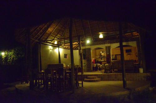 a gazebo at night with chairs in front of it at Irungu Forest Safari Lodge in Katunguru