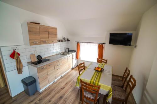 a kitchen with a table and chairs in a room at Stovka Božanov in Božanov