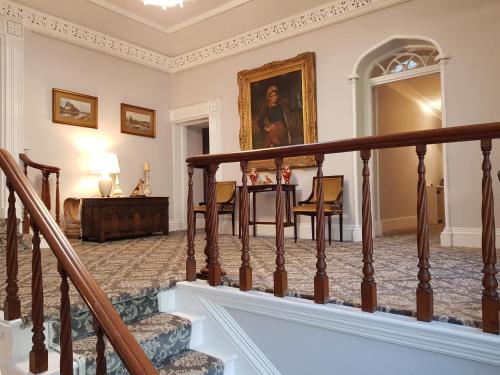 a staircase in a house with a table and chairs at Foxghyll Country House in Ambleside