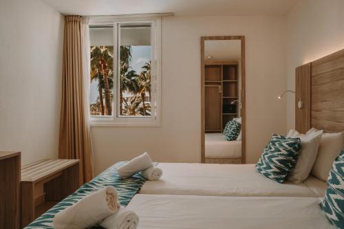 A bed or beds in a room at Playa Del Sol - Adults Only