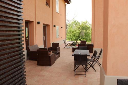 a patio with couches and chairs and a table at Agriturismo Ben Ti Voglio in Bologna
