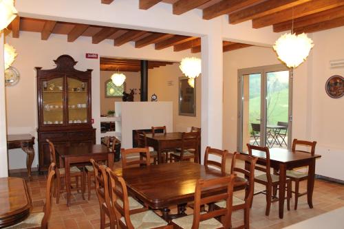 a dining room with wooden tables and chairs at Agriturismo Ben Ti Voglio in Bologna