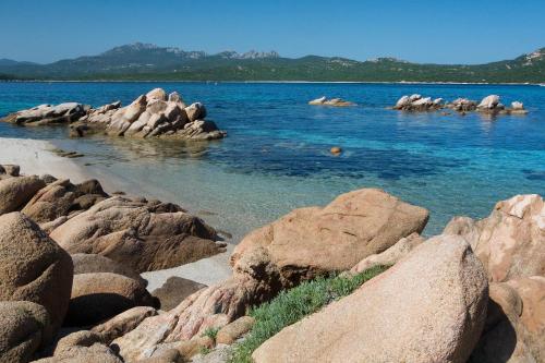 a large body of water with a bunch of rocks at Hotel Il Piccolo Golf in Porto Cervo