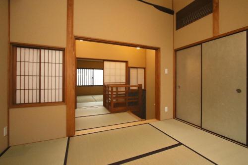 an empty room with a door and a room at Suiren Traditional Boutique Townhouse in Kyoto