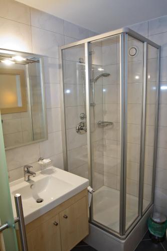 a bathroom with a shower and a sink at Pension Clara in Wattens