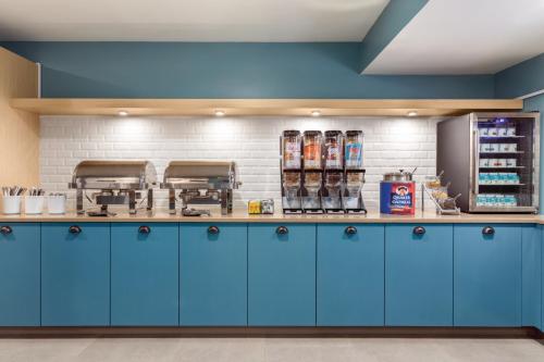a counter with blue cabinets in a kitchen at Country Inn & Suites by Radisson, Erie, PA in Erie