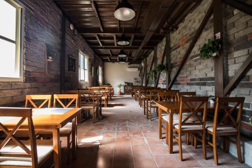 an empty restaurant with wooden tables and chairs at Yushow Library Villa in Nanzhuang