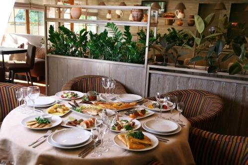 a table with plates of food on it in a restaurant at Kolyba House in Kyiv