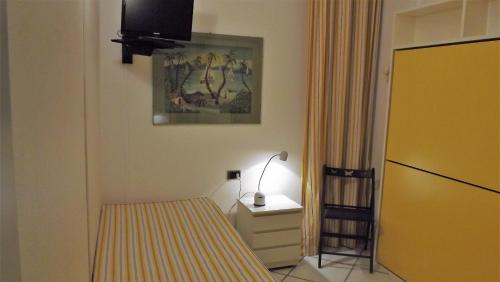 a bedroom with a bed and a dresser and a tv at House Giorgia by Holiday World in Santa Margherita Ligure