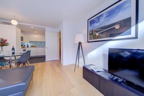 a living room with a large flat screen tv at Cleyro Serviced Apartments - Finzels Reach in Bristol