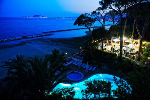 a view of the beach and the ocean at night at Grande Albergo Miramare in Formia