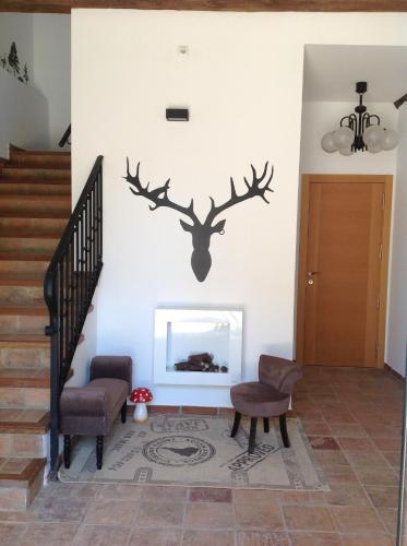 a living room with a wall with a deer decal at Apartamentos Turísticos Rincones del Vino in Ezcaray