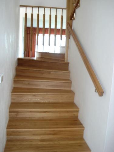 a staircase with wooden floors and white walls at Obora 827 Nova Bystrice in Nová Bystřice