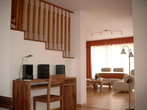 a living room with a staircase and a living room with a couch at Obora 827 Nova Bystrice in Nová Bystřice