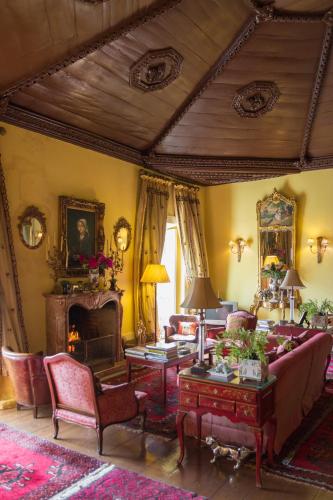 a living room with a couch and a fireplace at Hotel Rural Casa dos Viscondes da Varzea in Lamego