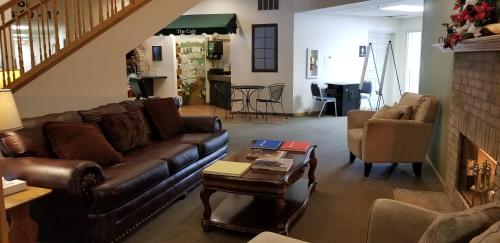 a living room with a couch and a table at Brook Pointe Resort in Syracuse