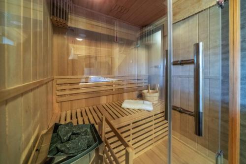 a sauna with a wooden floor and a glass door at Domek u Kowola in Szaflary