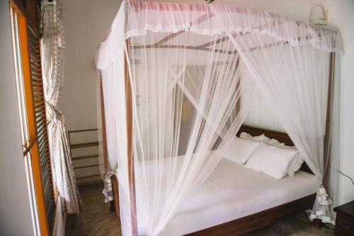 Ένα ή περισσότερα κρεβάτια σε δωμάτιο στο Kadolana Guest House