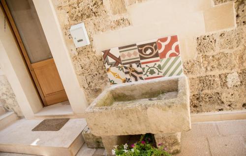 a stone sink in the corner of a bathroom at Suite Cavour B&B in Galatina