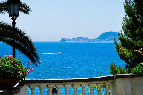 a view of the ocean with a boat in the water at Grande Albergo Miramare in Formia