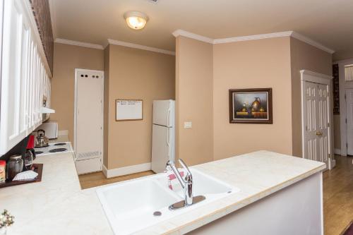 a kitchen with a sink and a refrigerator at Whiskey Row Penthouse in Prescott