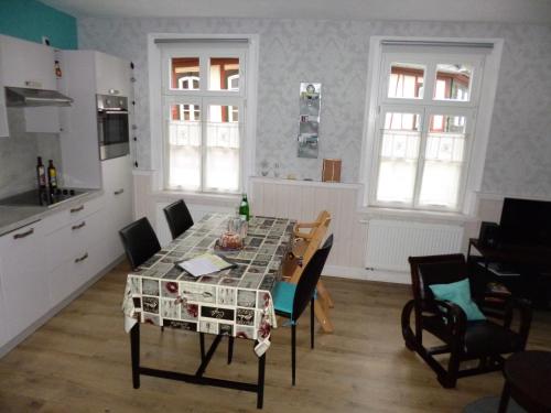 a kitchen with a table and chairs in a room at Gästehaus Rheinromantik in Bacharach