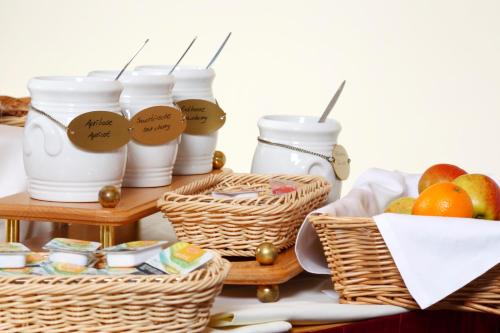 a table with baskets of food and fruit at VCH Hotel Greifswald in Greifswald