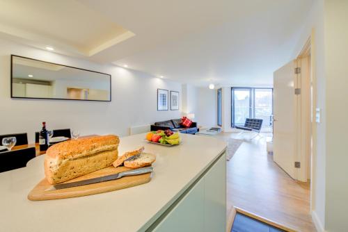 a loaf of bread on a counter in a kitchen at Cleyro Serviced Apartments - Finzels Reach in Bristol