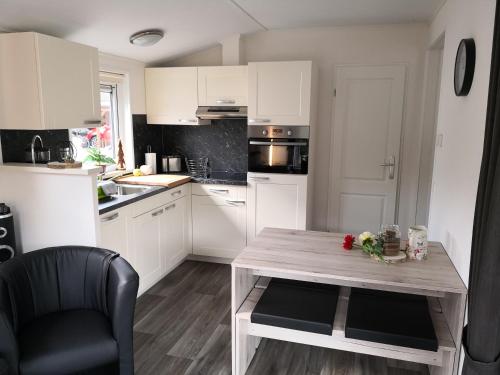 a kitchen with a wooden table with flowers on it at Ferienhaus MaLeFi 1 am Gülser Moselbogen in Koblenz