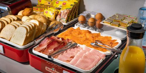 a buffet with different types of food on a table at Hotel Cortaccia Sanvitale in Sala Baganza