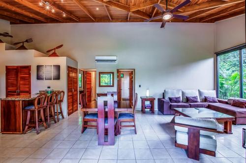 a living room with a couch and a table at Hidden Palms in Nosara