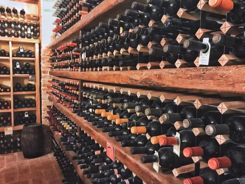 a room filled with lots of wine bottles at Fontanaro Farm and Culinary School in Paciano