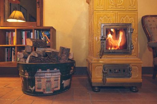 a wood stove with a fire in a room at Fontanaro Farm and Culinary School in Paciano