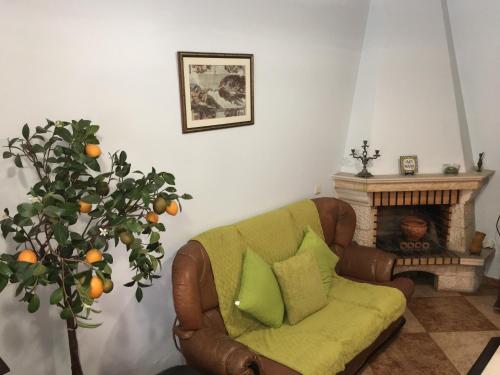 a living room with a couch and a fireplace at Ria Studios in Olhão