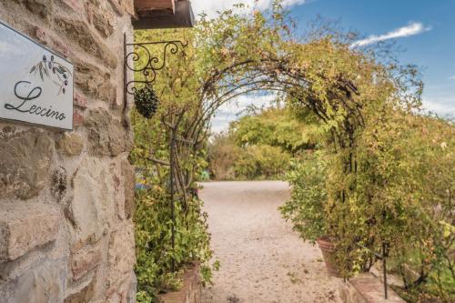 an entrance to a garden with an archway at Fontanaro Farm and Culinary School in Paciano