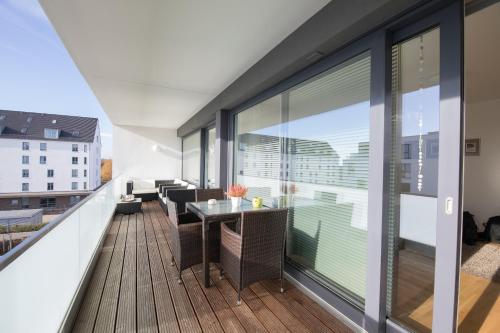 a balcony with a table and chairs on a building at Fewo Speicherquartier in Lüneburg
