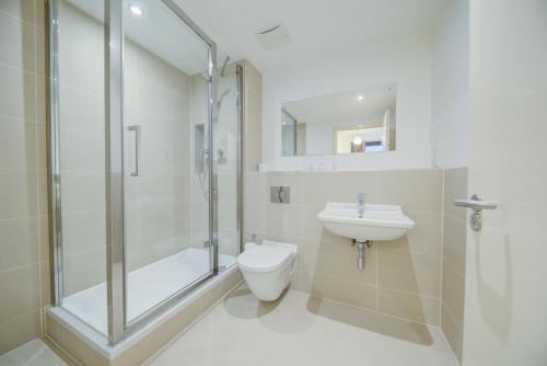 a bathroom with a shower and a toilet and a sink at Cleyro Serviced Apartments - Finzels Reach in Bristol