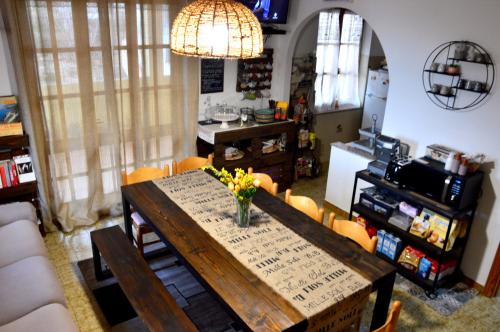 a dining room with a table and a kitchen at Mille Soli Bed and Breakfast in Buggerru