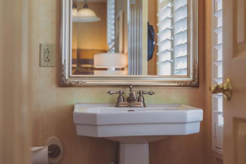 a bathroom with a white sink and a mirror at The Parkview Hotel in Syracuse