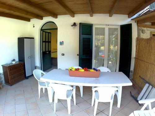 a table with chairs and a box of fruit on a patio at Come a casa in Deiva Marina